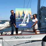 Holding this canvas is Artist Joe Barsin and Woodwind Captain Jenn Kaye